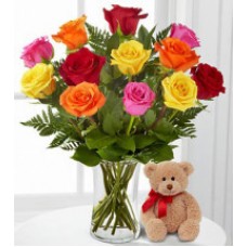 Bunch of colorful roses with teddy